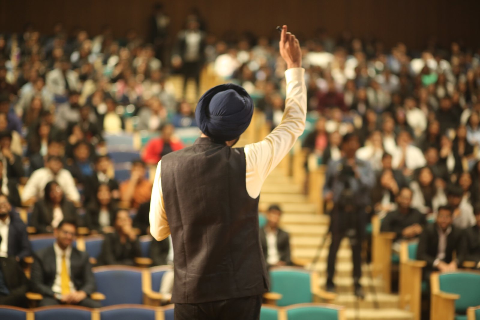 Harjeet addressing a packed auditorium of students