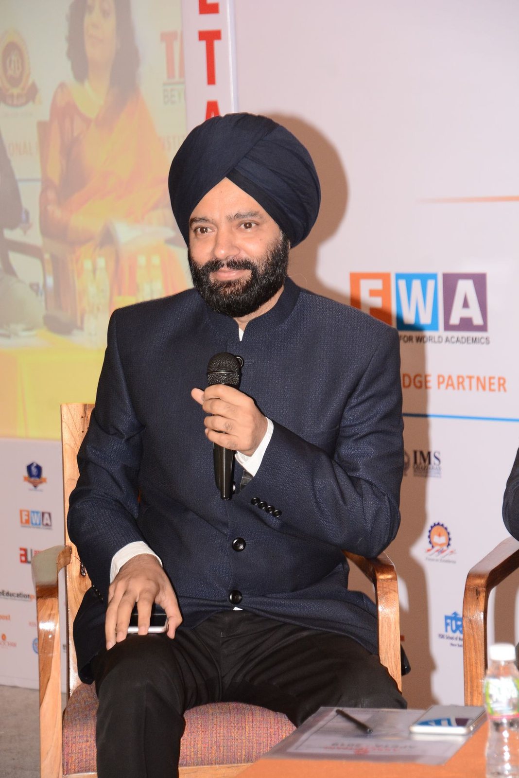 Harjeet speaking on a panel at a Federation of World Academics event