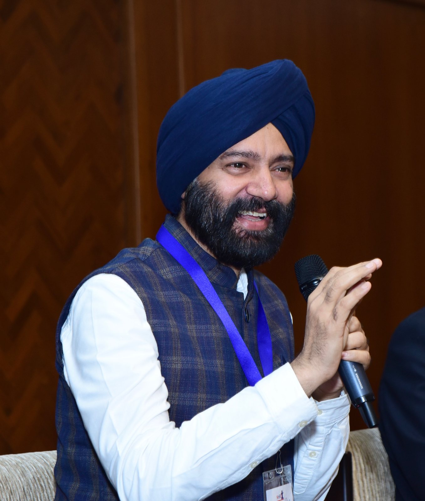 Harjeet laughing as he speaks at an NHRD session