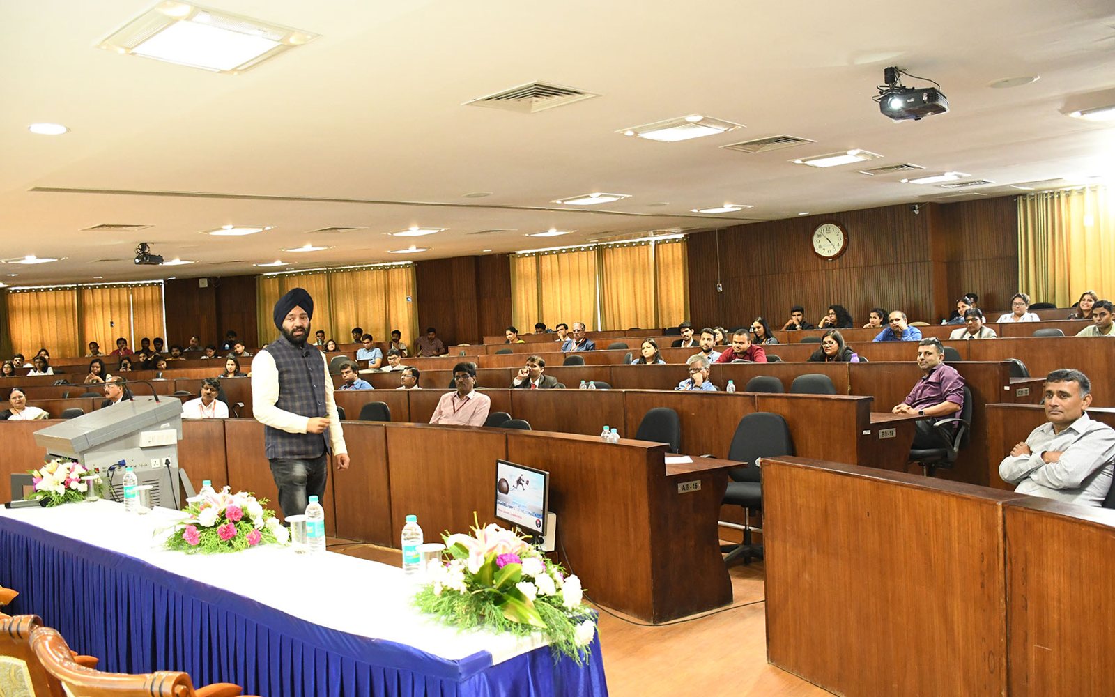 Harjeet addressing a lecture hall of professionals